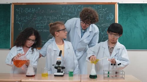 Children Doing Science Experiment in Classroom with Teacher