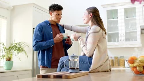 Loving Couple Drinking Coffee Together in Kitchen