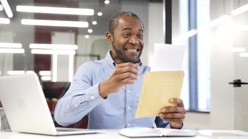 Man Receives Good News in Office and Celebrates