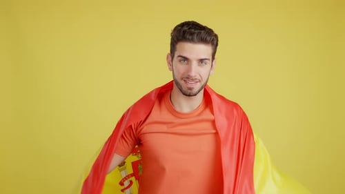Smiling Young Adult with Spanish Flag in Studio
