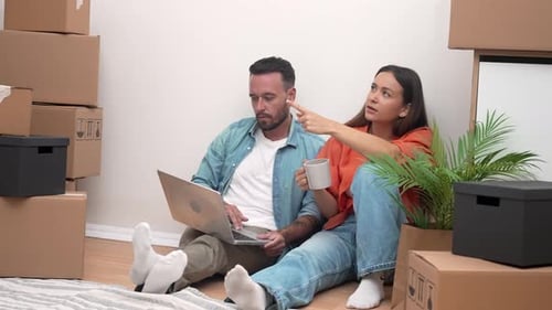 Young Couple Planning New Home with Laptop
