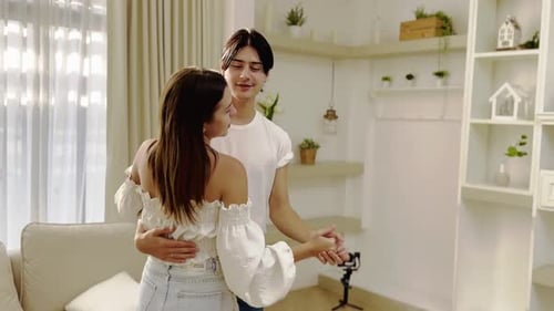 Young Couple Dancing Together in a Sunlit Living Room