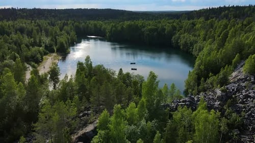 Boats Float on the Lake the Shores of Which are Covered with Coniferous Forest
