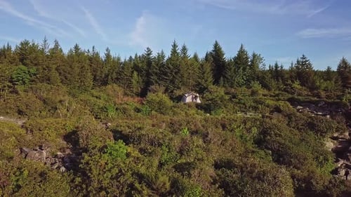 Young Man Standing In Front Of Camping Tent In Epic Mountain Landscape Aerial Cinematic 4K