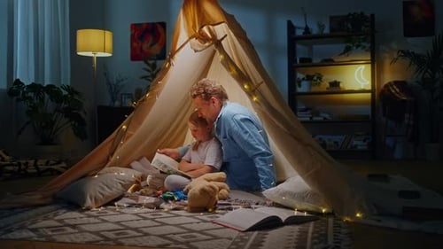 Dad and Daughter Reading Book in Cozy Tent