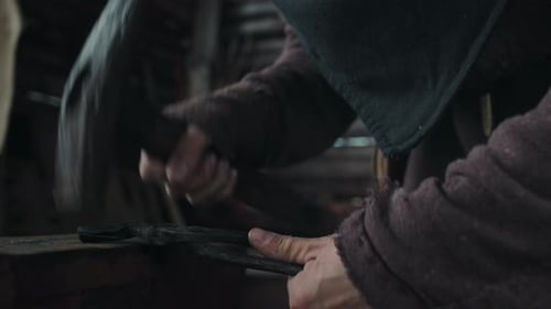 Blacksmith Hand Forging Metal with Hammer and Anvil