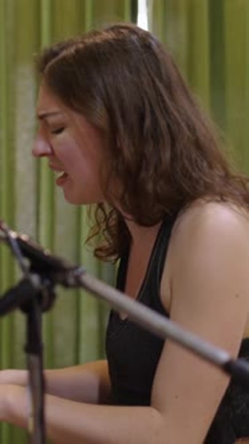 Young Woman Singing and Playing Piano