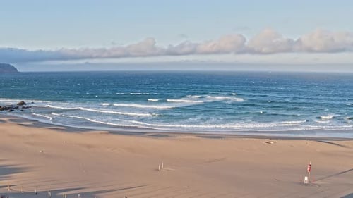 Aerial Drone View of Waves Breaking onto Sandy Beach Shore