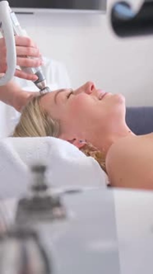 Woman Receives Facial Treatment at Medical Spa