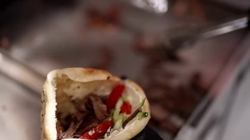 Preparing delicious pita sandwich with meat