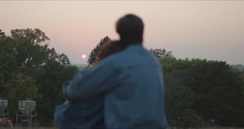 Romantic Couple Embracing During Scenic Sunset
