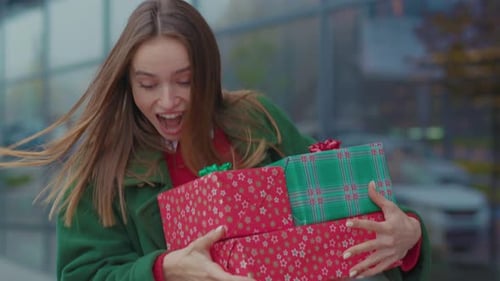 Smiling Woman Holding Gifts Outside of Storefront