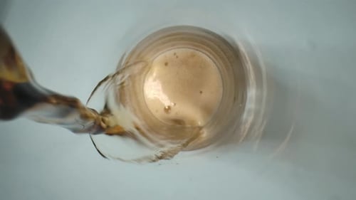 Brown Beverage Poured into Glass Close Up
