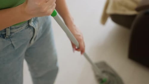 Close Up of Homecare Worker Mopping Floor in Living Room