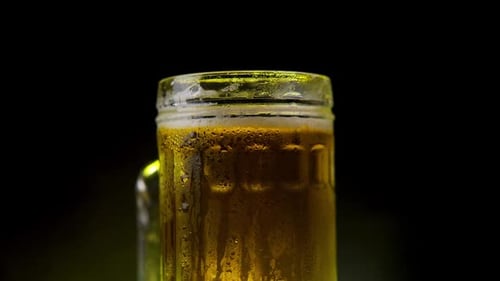 Cold Beer Mug Rotating on Black Background