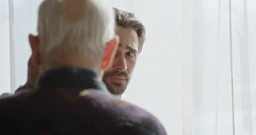The Last Farewell to an Adult Son with an Old Father Near the Window Strong Emotional Scene