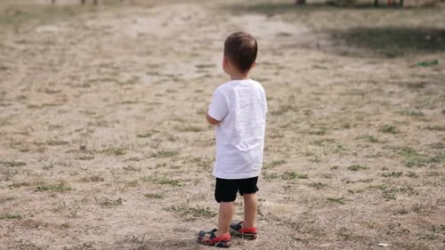 Playing outdoor in park small child. Baby boy playing in the park.