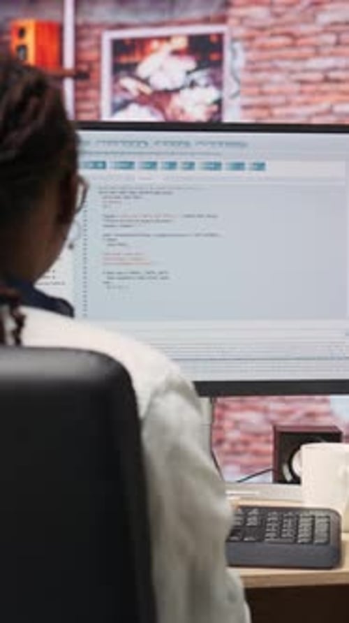 Vertical Video IT Expert in Home Office Working with Code Editor