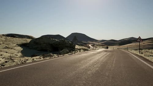 A Winding Road Through Mongolias Vast Arid Landscape Under a Clear Sky