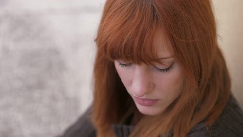 Woman with Red Hair in Contemplative Mood