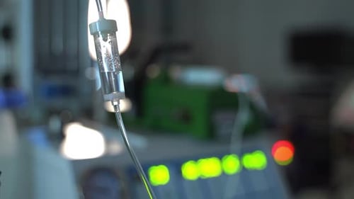 Medicine drops fall in the drop counter. Dropper close up.