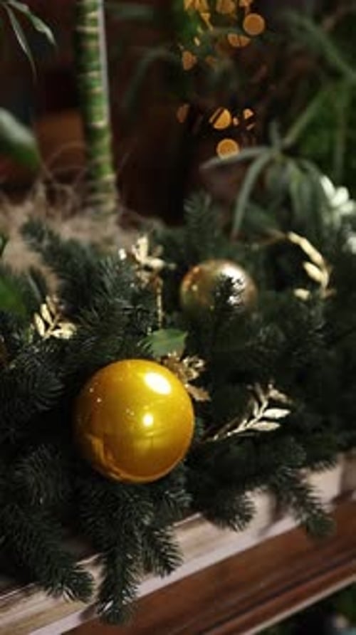 Gold Christmas Ornaments on Pine Branches Close-up