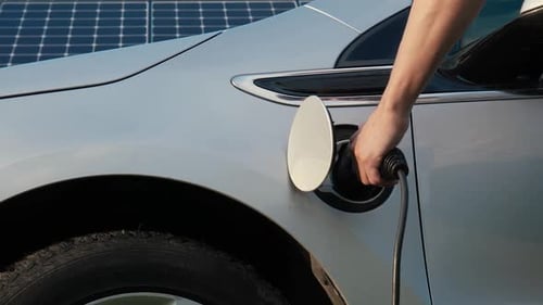 Electric Car Charging Next to Solar Panels