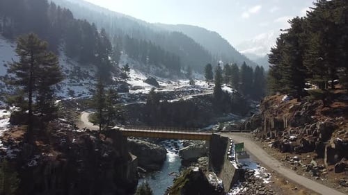 Bridge Across a Snowy Mountain River