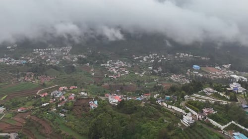 Picturesque view of Kodaikanal's valleys dotted with homes and winding roads