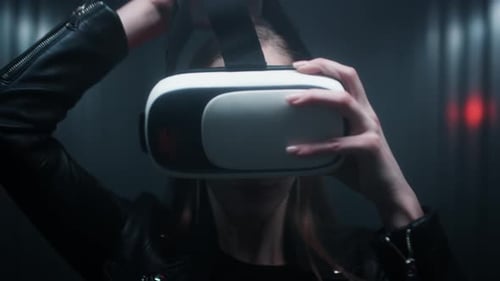 A Beautiful Young Girl Puts on Virtual Reality Glasses on Her Head