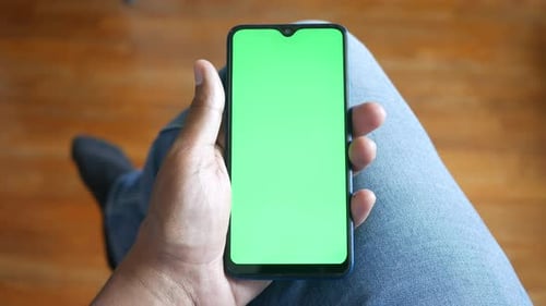 Close Up of Young Man Hand Using Smart Phone with Green Screen