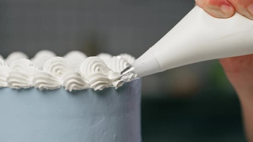 Cake Decorating with White Frosting for a Birthday
