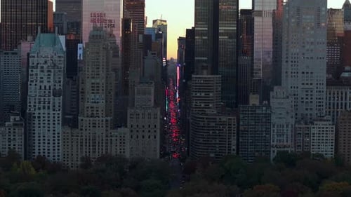 Sunset Casts a Warm Glow Over the New York City Skyline Illuminated Skyscrapers and Bustling Streets