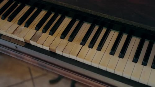 Close-up of an old piano keyboard with worn keys