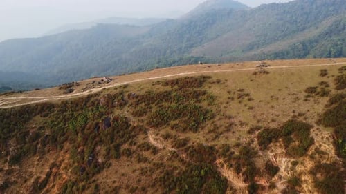 Aerial view of treeless mountain range destroyed by humans.