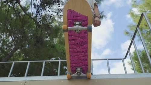 young boy on skateboard getting ready to slide on the ramp. bottom view. 4K.
