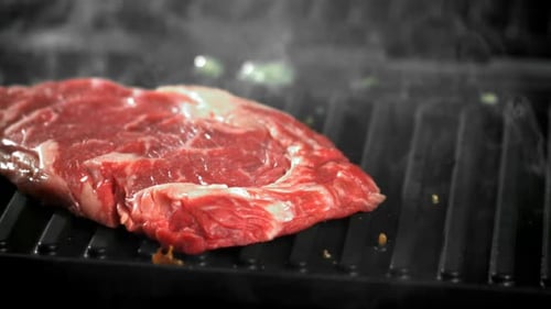 The Ribeye Steak Falls Into the Pan Filmed on a Highspeed Camera at 1000 Fps