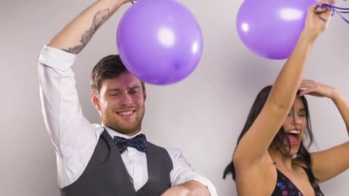 Happy Couple Dancing with Purple Balloons Celebration