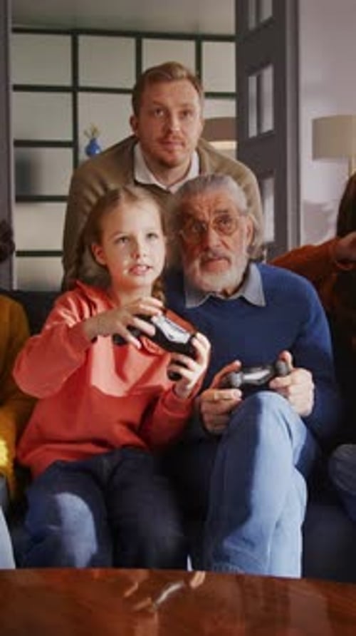 Multi-Generational Family Playing Video Games on Sofa