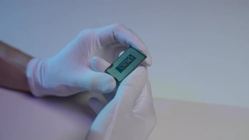 Closeup High Angle View of Unrecognizable Computer Technician in Latex Gloves Holding in Hands CPU