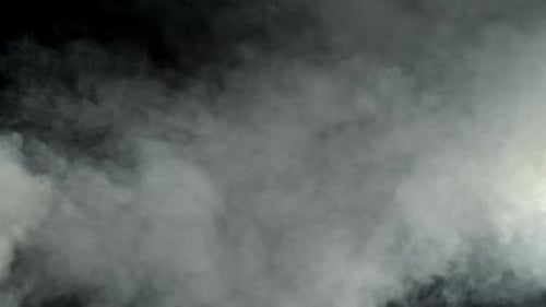 Wispy white smoke against black background, foggy atmosphere