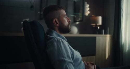 Stock Exchange Trader Sitting in Chair and Looking at Window Relaxing After Successful Trading Day