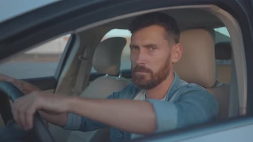 Man Smiling From Inside Car During Daytime