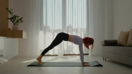 Woman Exercising Doing Yoga at Home
