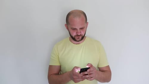 Bearded Man Using Mobile Phone Indoors