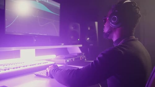 African American Sound Engineer Creating Electronic Music in Studio