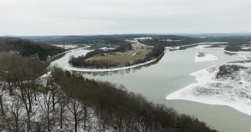 Harmonious Ozarks scenery - a lake frozen in stillness and dormant woodland.