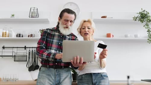 Senior Couple Shopping Online at Home with Laptop