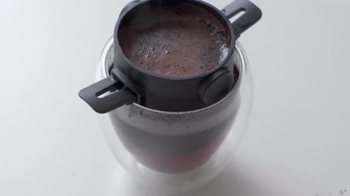 Hot Black Coffee In Double Wall Glass With Pour Over Filter. close up, high angle