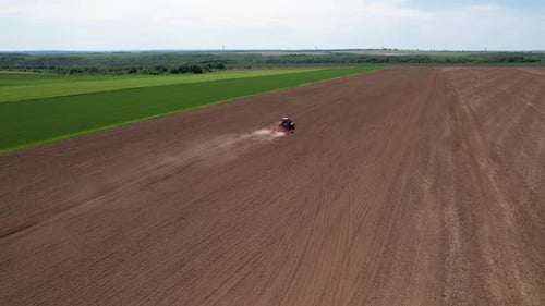 Aerial view of tractor tilling soil, Bulgaria.